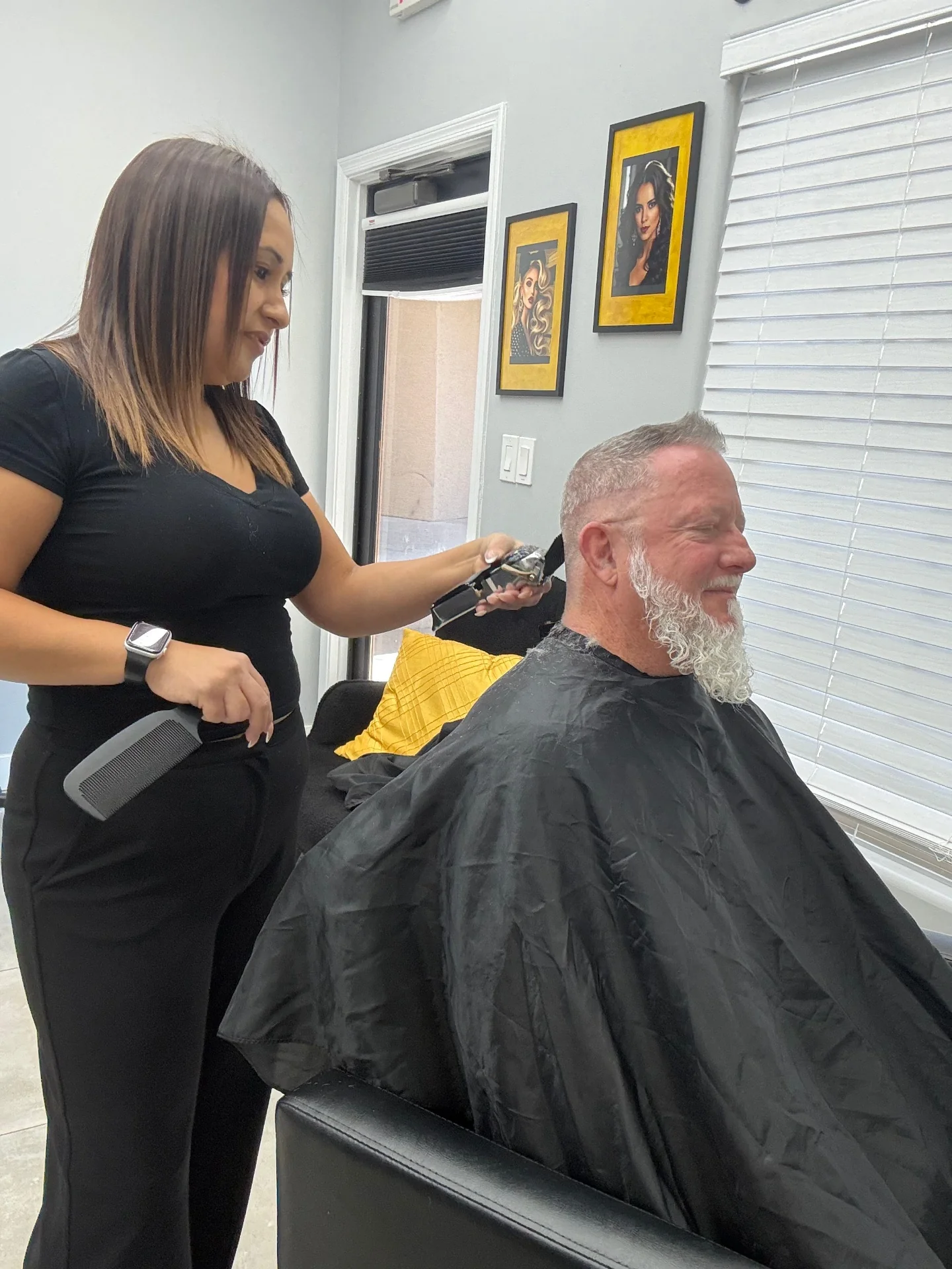Stylist trimming a client's hair with clippers at Hair Ambition mobile barber in Goodyear, AZ