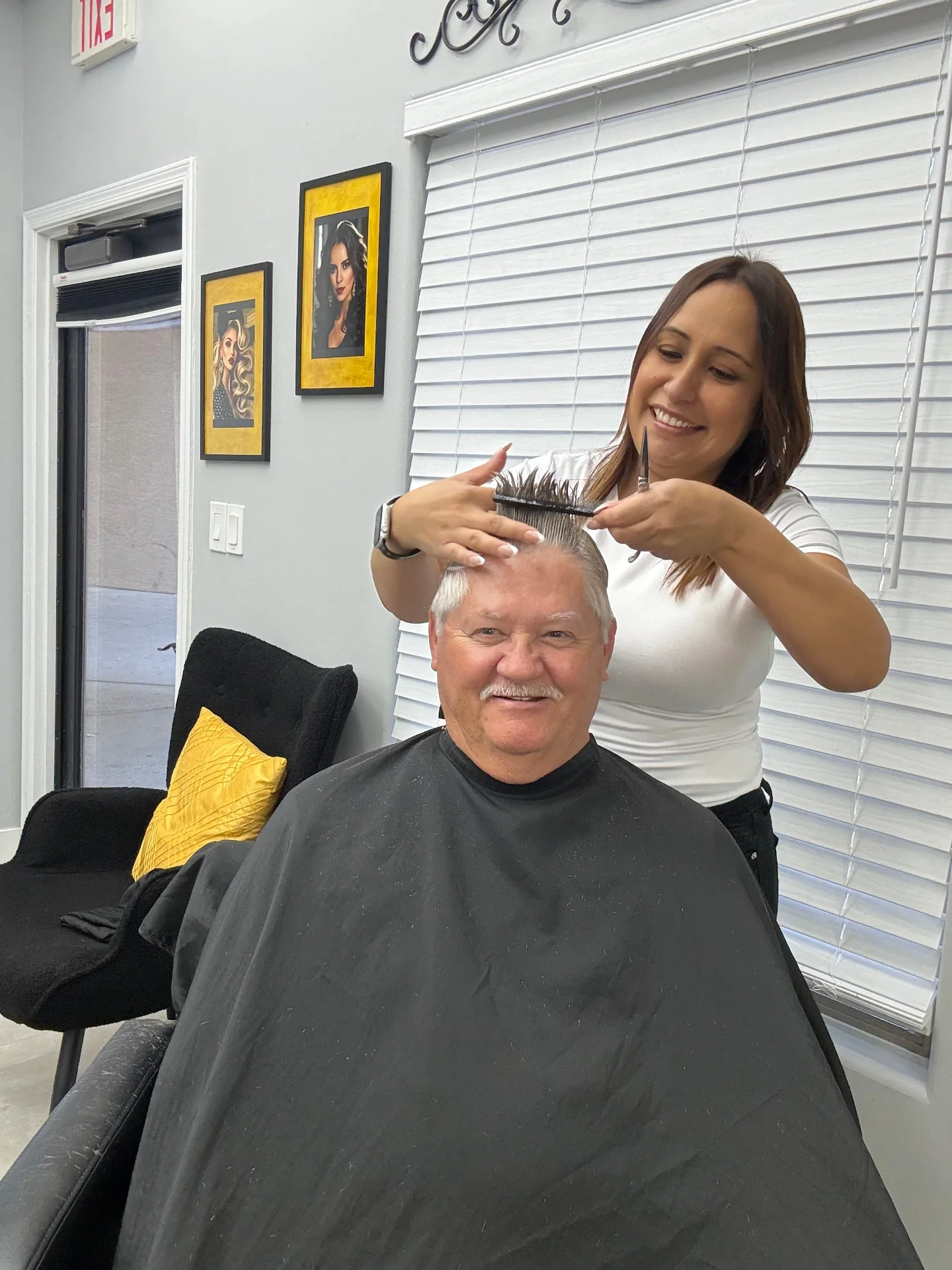 Senior client smiling during an in-home haircut visit from Hair Ambition mobile barber in Goodyear, AZ